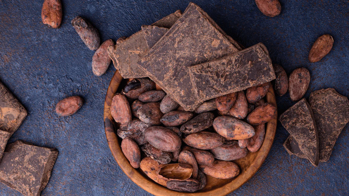 Raw cacao beans and dark chocolate pieces on a rustic background – nutrient-rich superfood packed with antioxidants, perfect for healthy snacking and baking.