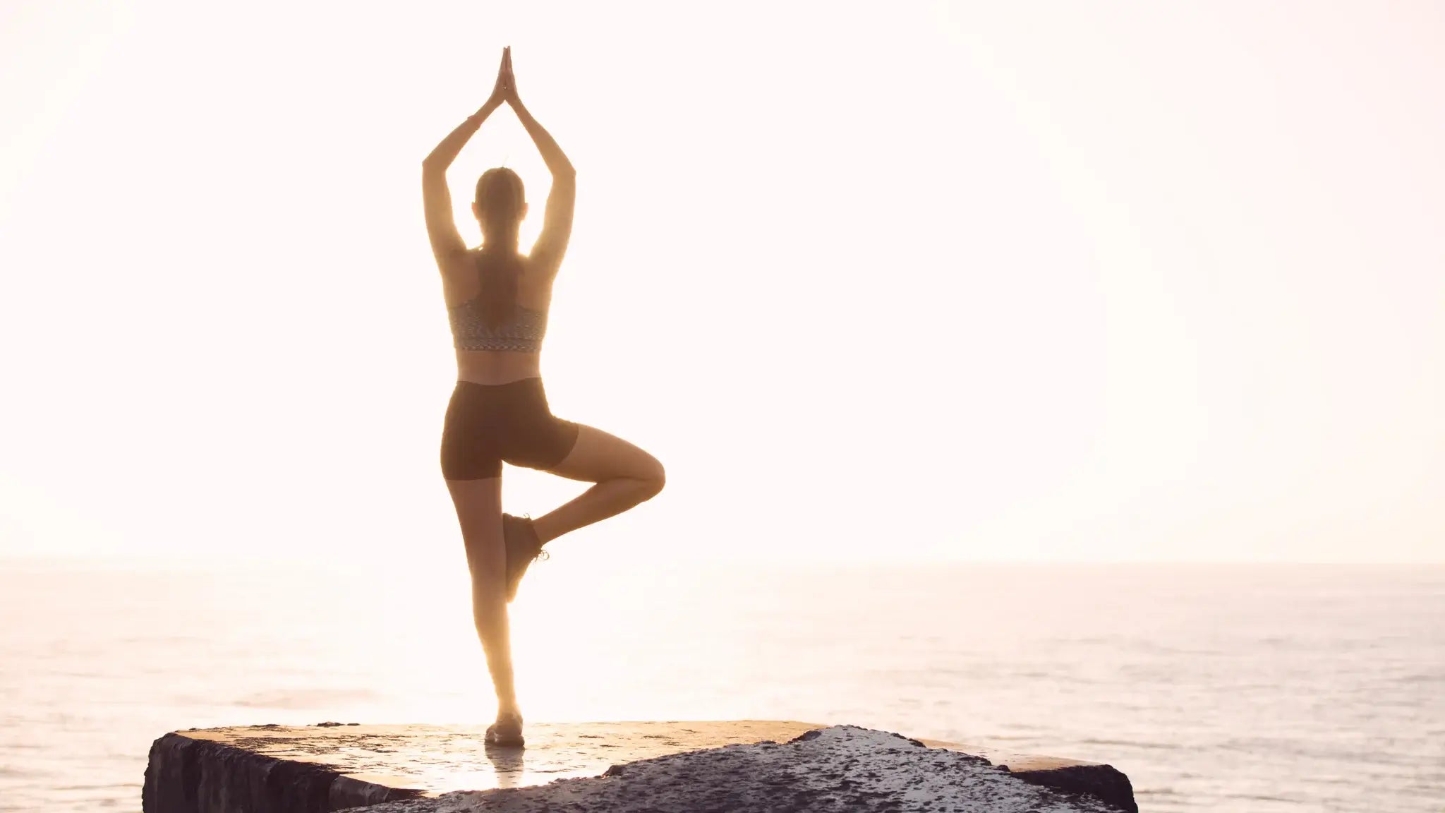 Woman balancing doing yoga; Balance your hormones